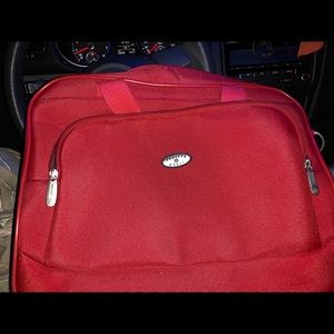 Medium red travel bag on wheels